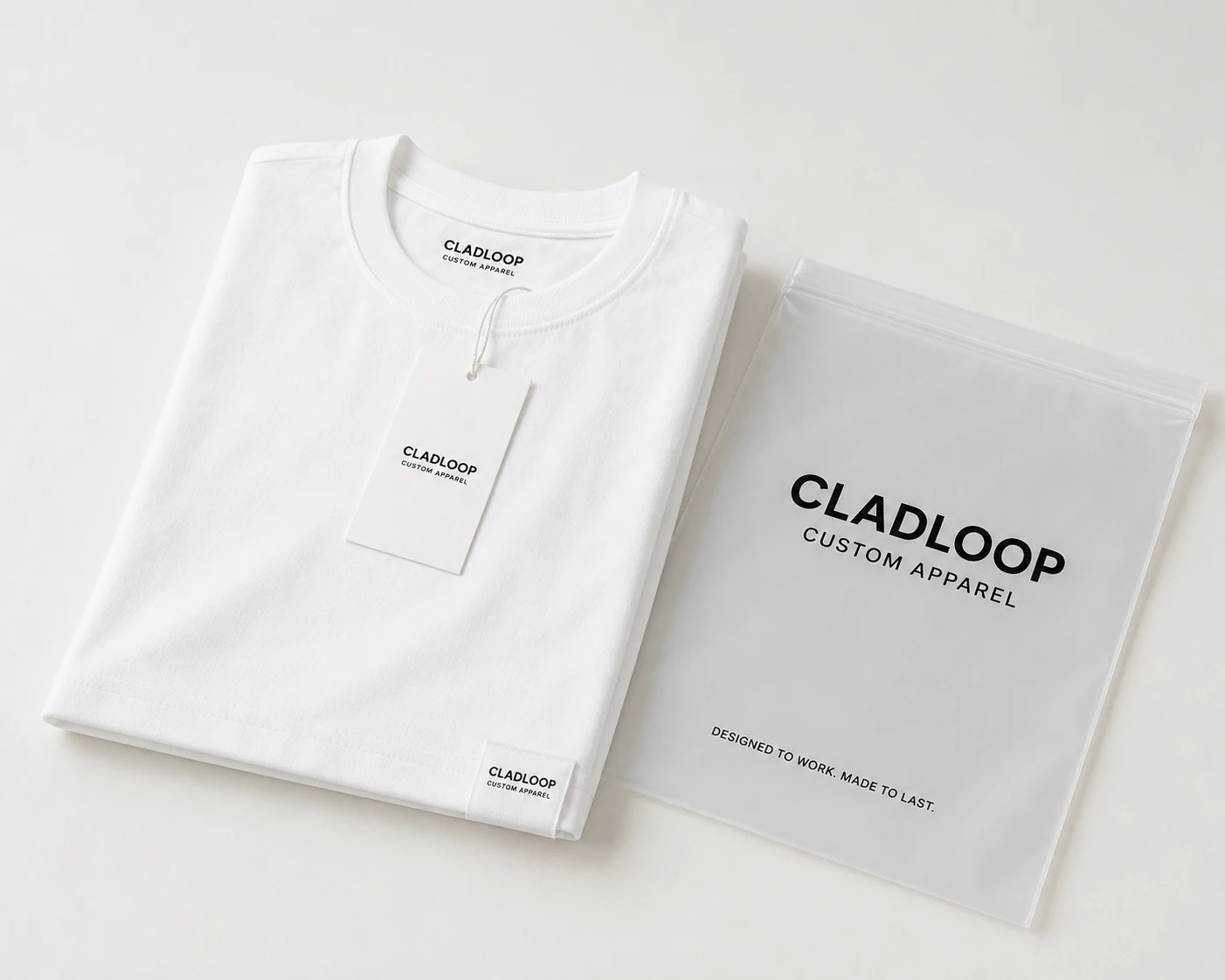 Folded white branded T-shirt beside its project packaging